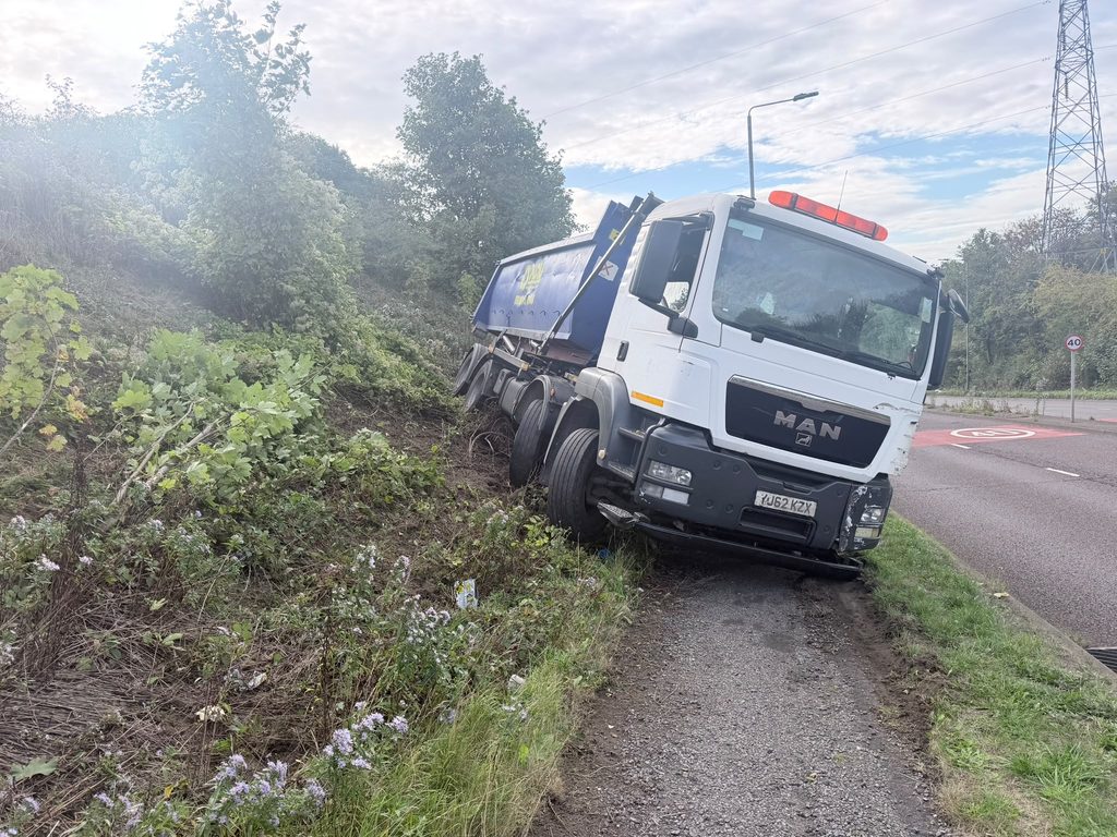 HGV and KCM RoRo container on the banking after rolling downhill in Greasbrough